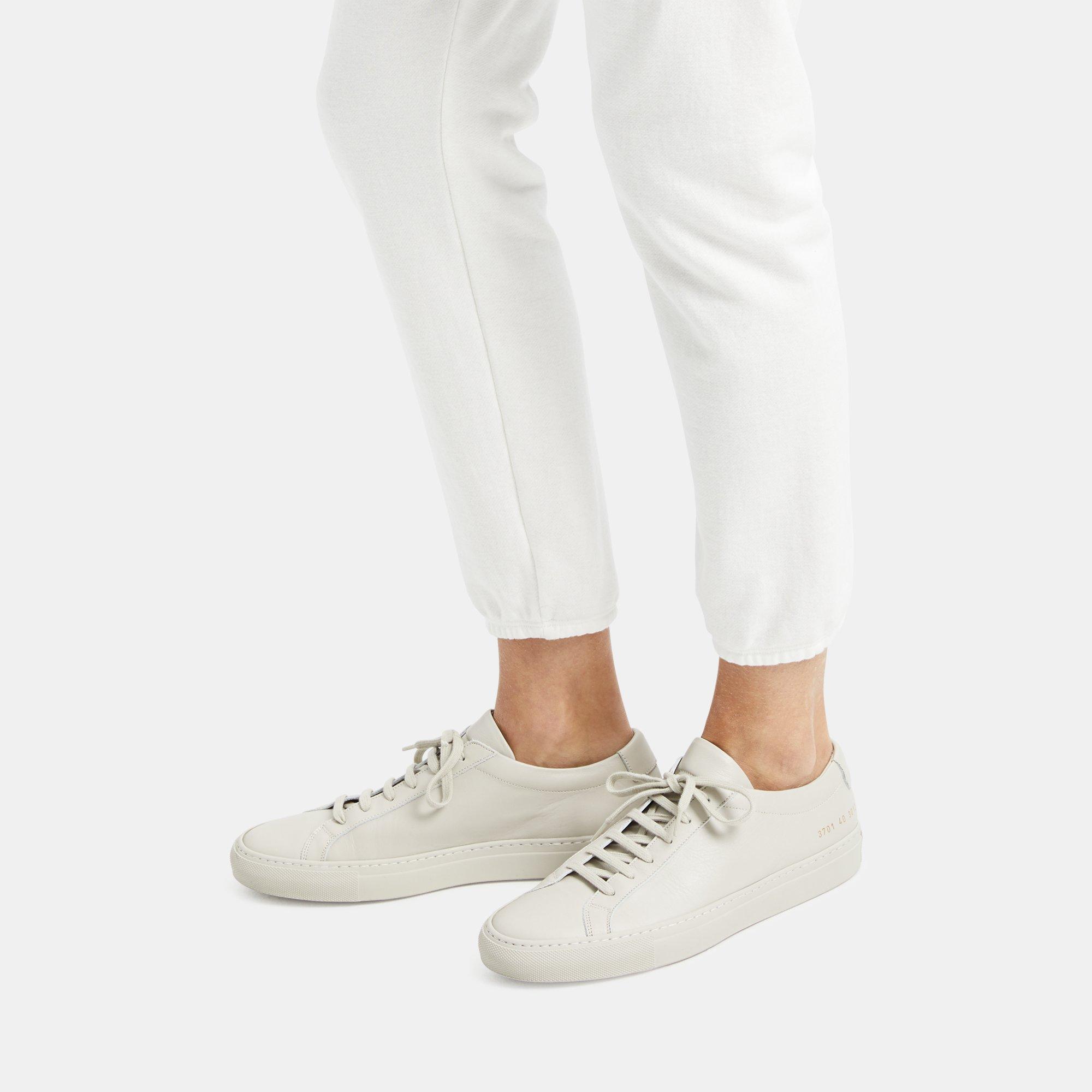 white sneakers with gold numbers