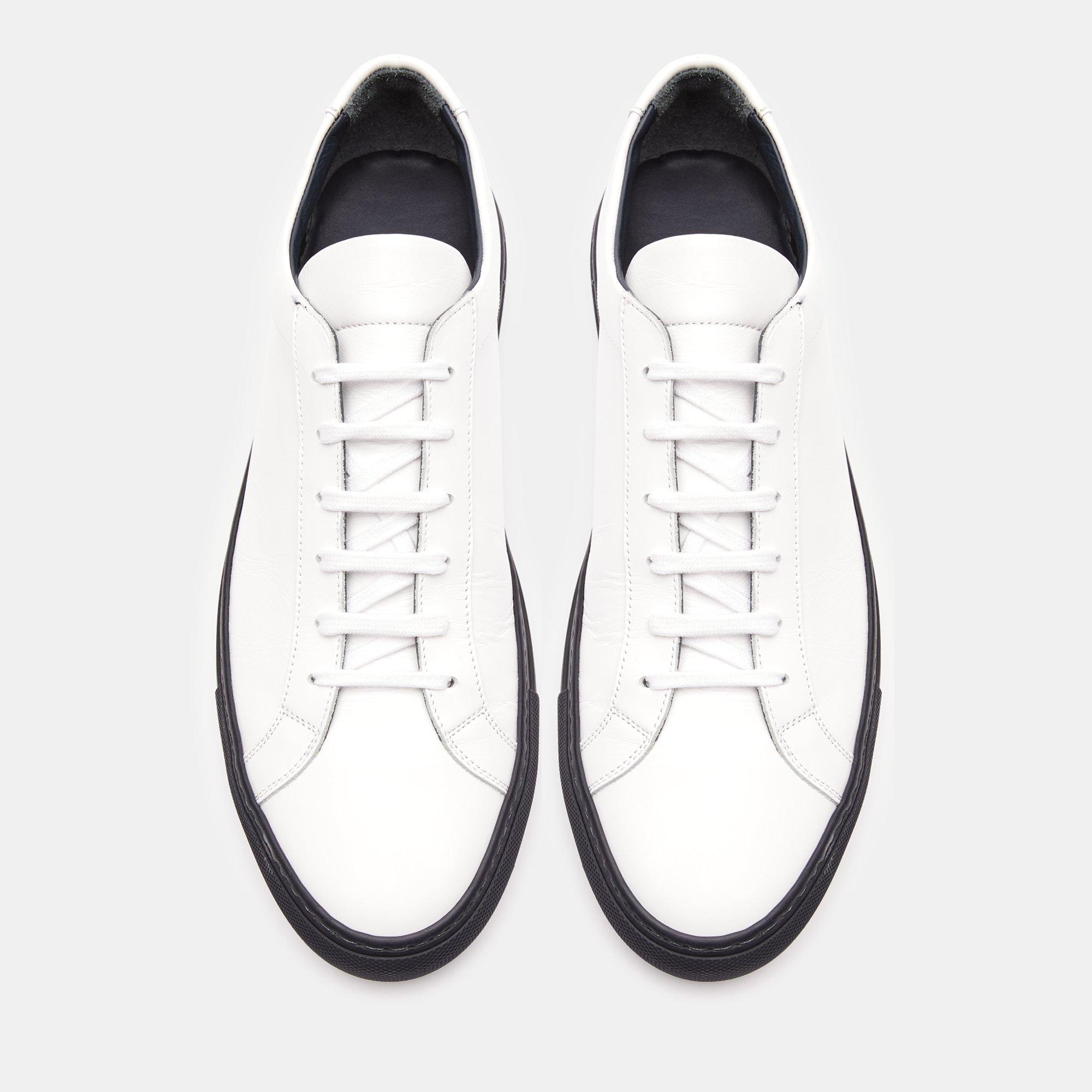 white sneakers with gold numbers